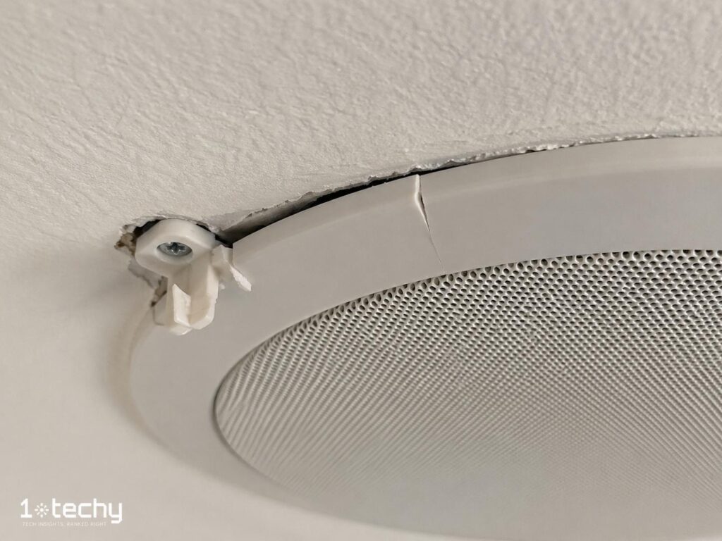 Damaged ceiling speaker mounting ring from overtightening during installation — common ceiling speaker installation mistake